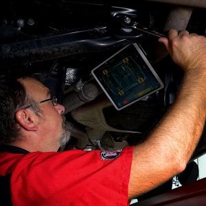 Technician using the Rotary R1090 Pro 3D Wheel Alignment Machine for vehicle alignment