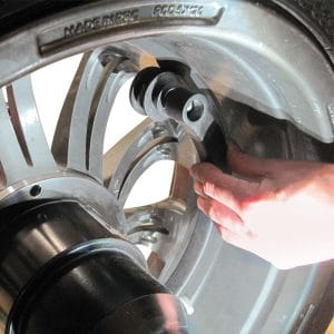 Technician adjusting Rotary R155 Pro 3D Wheel Balancer for precise measurement