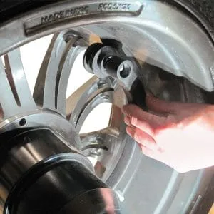 Technician adjusting Rotary R155 Pro 3D Wheel Balancer for precise measurement