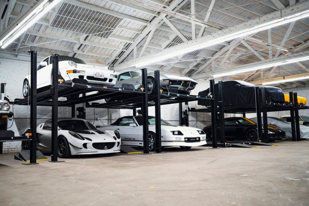 4 post lift buying guide. 4 post car lift in a home garage used for vehicle storage and parking space optimization