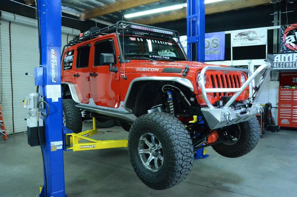 jeep on forward two post lift. 2 post lift buying guide.