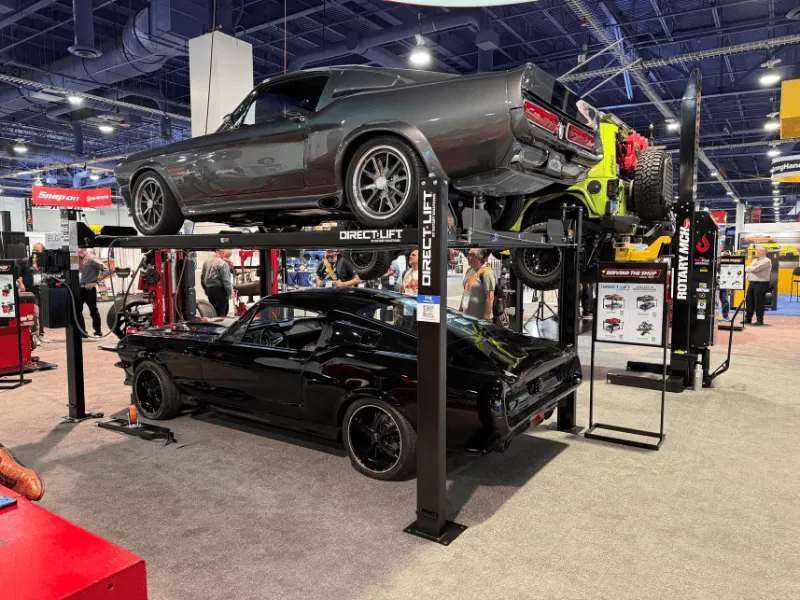 Direct Lift four-post lift with classic cars on display at SEMA 2026 booth 80026