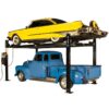 Yellow vintage car elevated above a blue classic pickup truck on a four-post car lift, showcasing the lift's capability for storing classic and vintage vehicles.