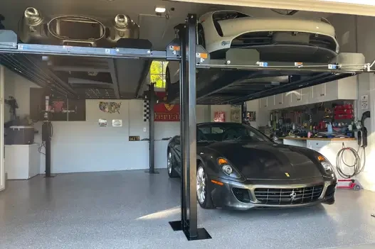 Ferrari and Corvette vehicles stored using 4-post lifts in a high-end home garage